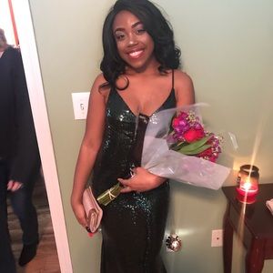 An emerald sequin dress; slight mermaid kick